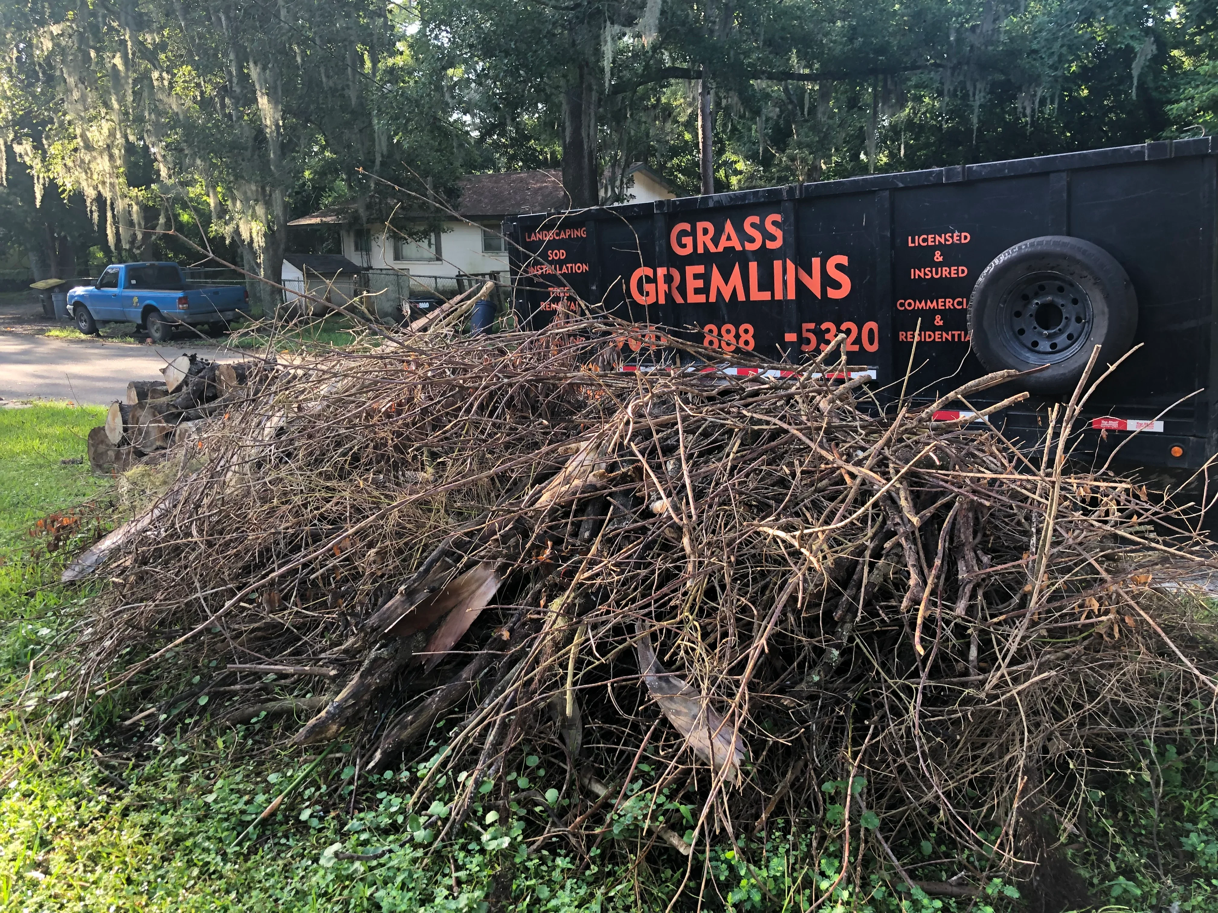 Loaded trailer with branches, brush, and yard debris removal from residential property